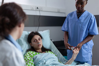 Doctor and nurse examining patient at clinic