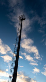 Low angle view of crane at construction site against sky