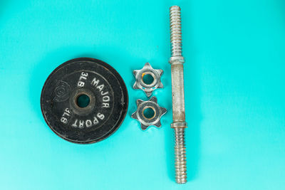 Directly above view of weights on turquoise background