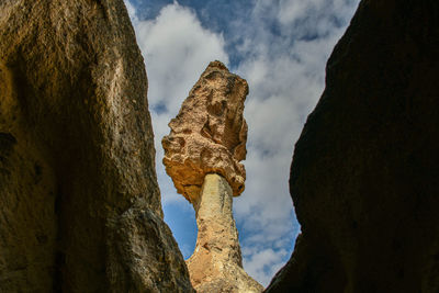 Low angle view of statue against rock formation
