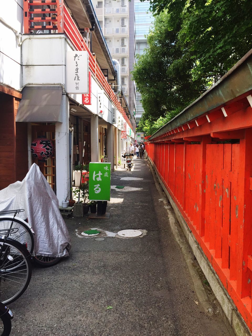 built structure, architecture, building exterior, transportation, city, street, building, day, communication, mode of transportation, the way forward, road, land vehicle, outdoors, incidental people, text, direction, diminishing perspective, red, people