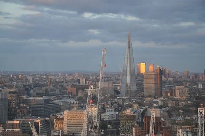 View of cityscape against cloudy sky