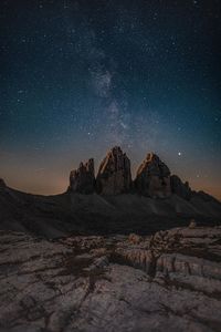 Scenic view of rock formations against sky at night