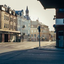 Empty street amidst buildings in city