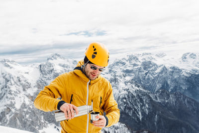 Side view of man skiing on snowcapped mountain