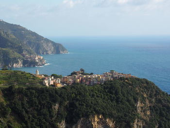 Scenic view of sea by buildings against sky