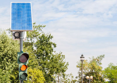 Close-up of road sign against sky