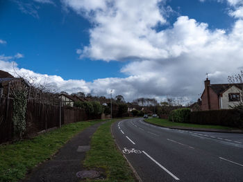 Road amidst buildings against sky in city