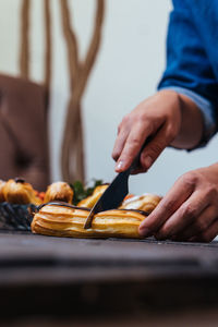 Midsection of man holding ice cream on table