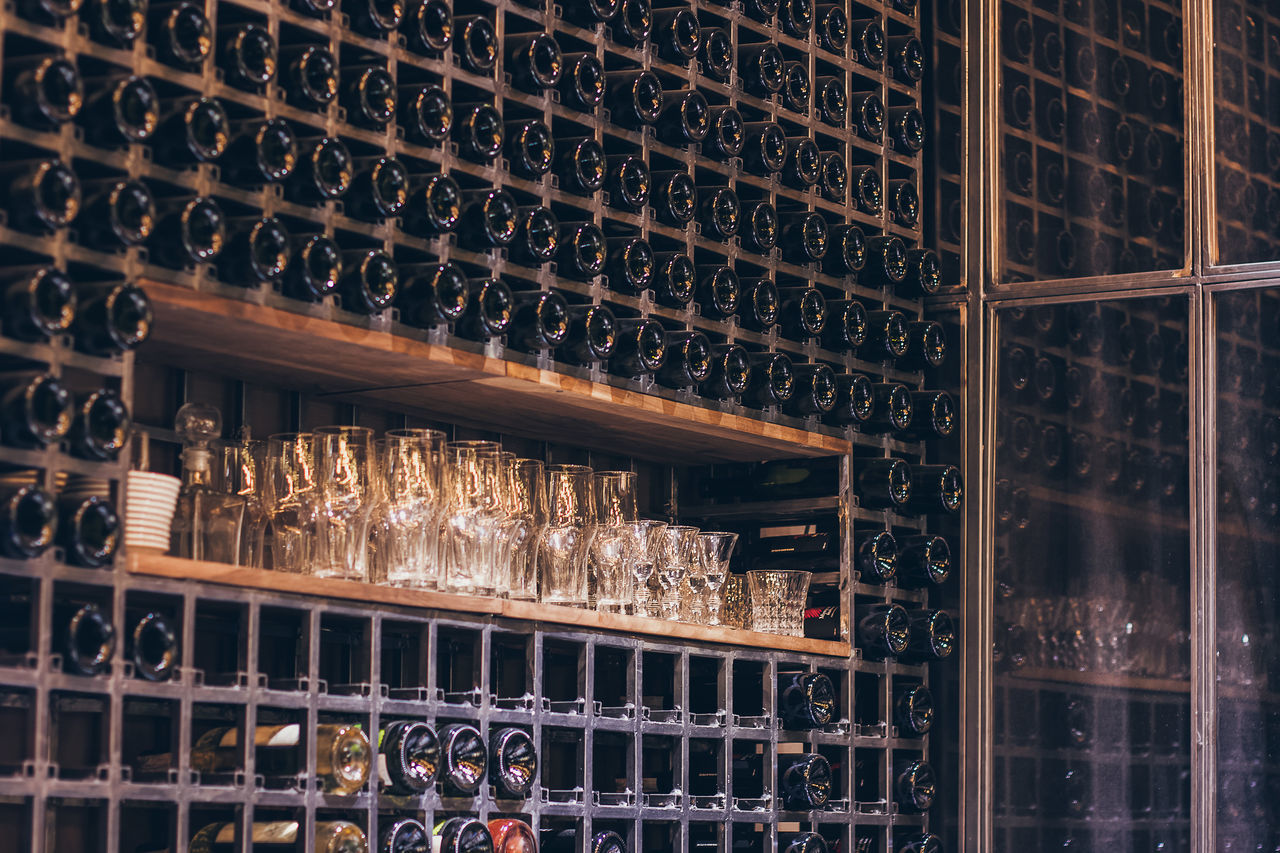 FULL FRAME SHOT OF WINE BOTTLES ON SHELF