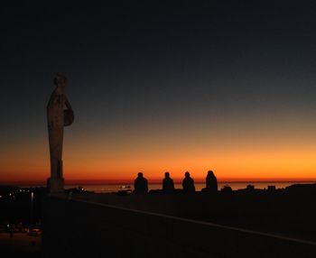 Silhouette people against sky during sunset