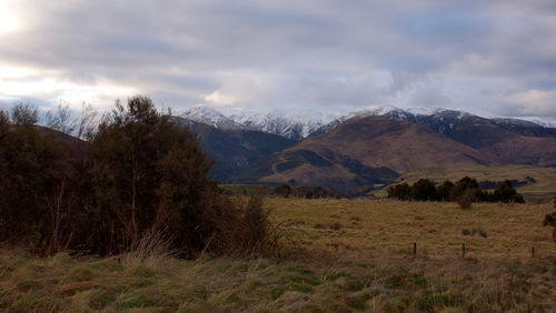 Scenic view of mountains against cloudy sky