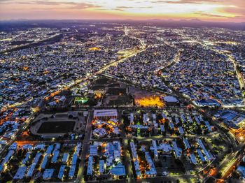 High angle view of city lit up at night