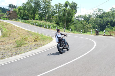 Man riding motorcycle on road