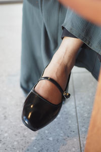 Low section of woman wearing shoes