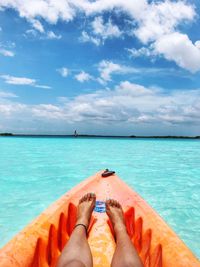 Low section of woman in boat against sky