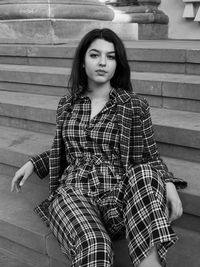 Portrait of young woman sitting outdoors