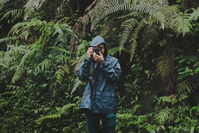 Full length of man standing in forest