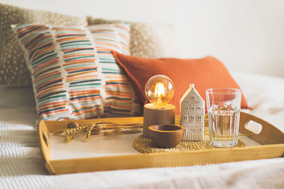 Linen pillows on a white bed with home decor. still life details in home on a bed. cozy home.