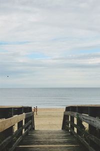 Jetty on sea against sky