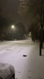 View of illuminated street at night during winter