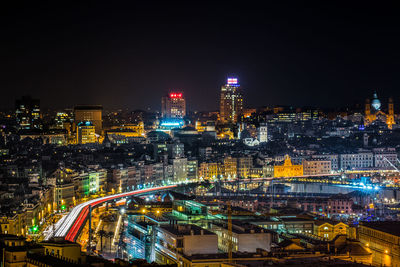 High angle view of illuminated buildings in city at night