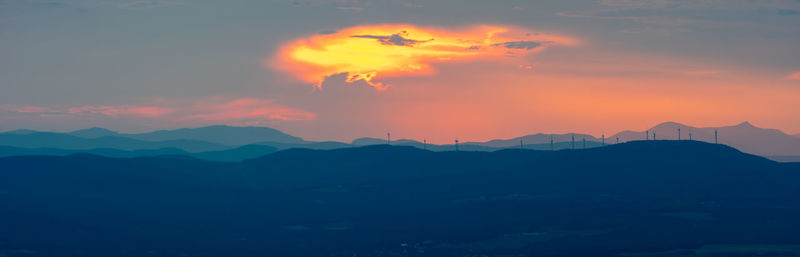 Scenic view of silhouette mountains against sky at sunset