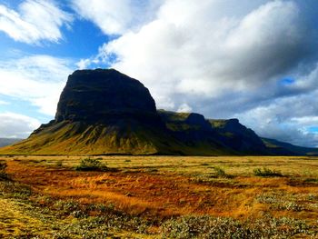 Scenic view of mountain against cloudy sky