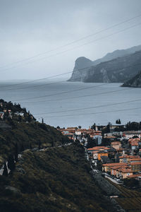 Scenic view of town by sea against sky