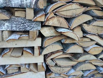 Chopped birch firewood stacked on top of each other in a woodpile