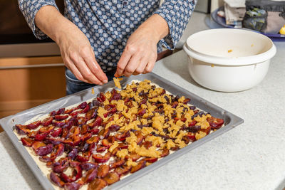 Midsection of person preparing food on table