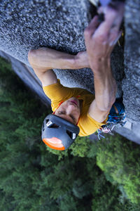 Man placing big cam in granite off-width crack lead climbing squamish