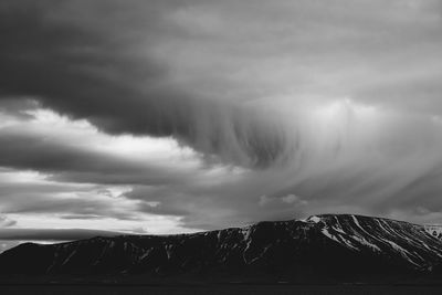 Scenic view of storm clouds over landscape