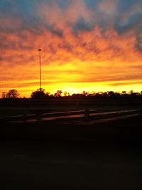 Scenic view of silhouette landscape against orange sky