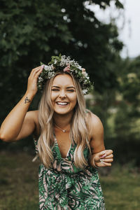 Happy woman wearing wreath of flowers