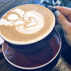 Close-up of cappuccino served on table