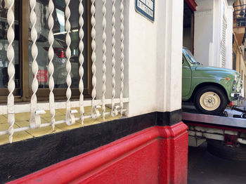 Red car parked in front of building