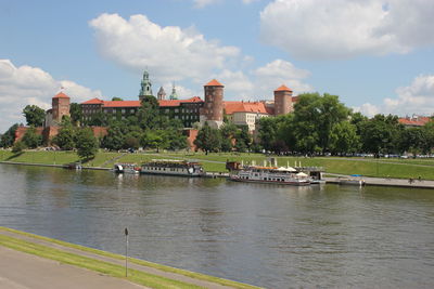 Bridge over river in city against sky