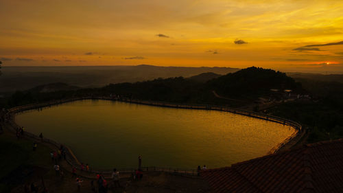 Scenic view of river against orange sky