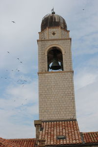 Low angle view of bell tower against sky