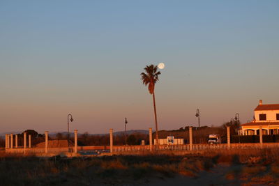 Scenic view of building against clear sky during sunset