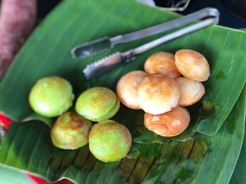 High angle view of fruits and leaves on table