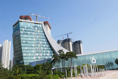 Low angle view of modern buildings against clear blue sky