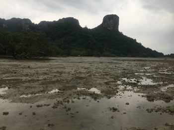 Scenic view of sea and mountains against sky