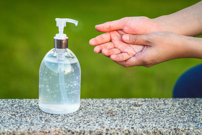 Close-up of hand holding glass bottle