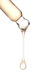 Cropped hand holding wineglass against white background