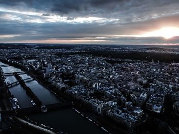 Aerial view of city against cloudy sky