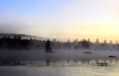 Scenic view of lake against sky during sunset