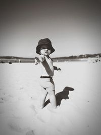 Full length of boy on beach against sky