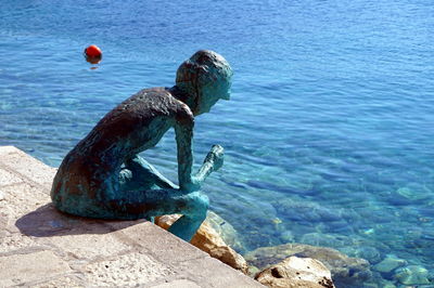Sculpture of rock in sea